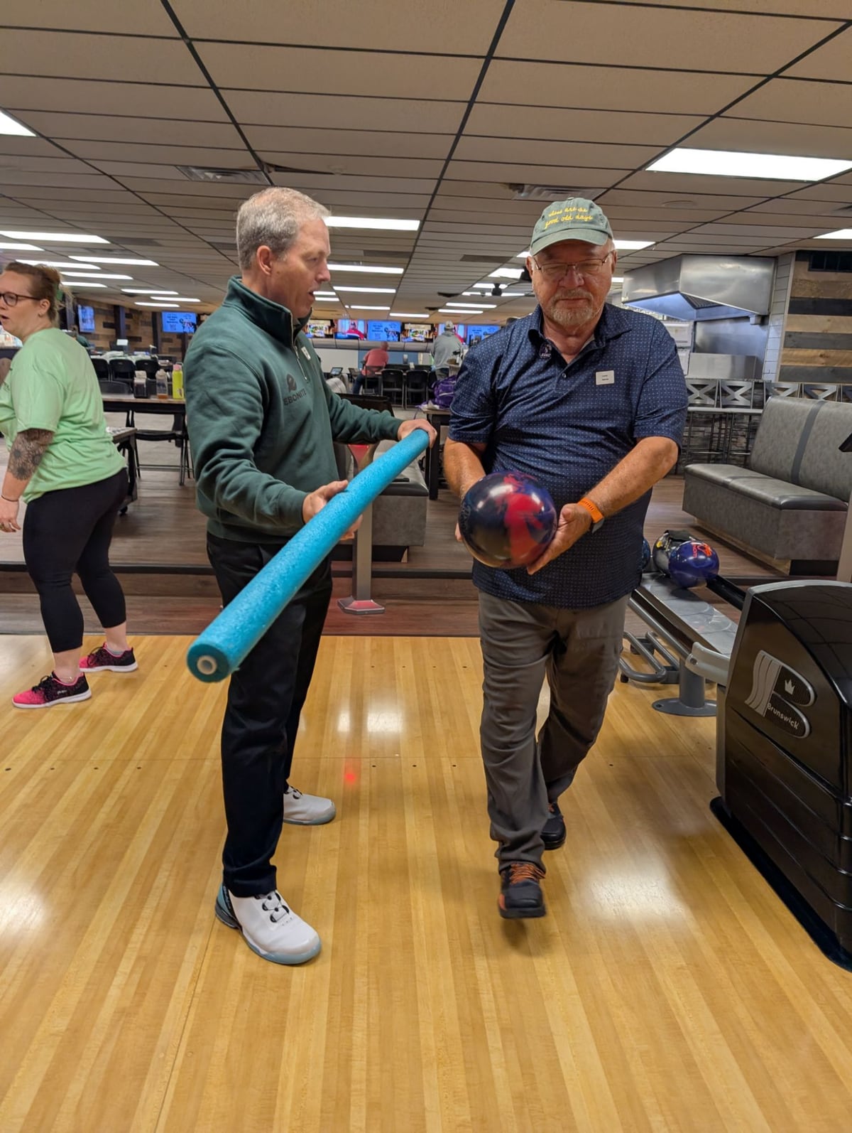 Mike Shady coaching a bowler with a foam noodle drill