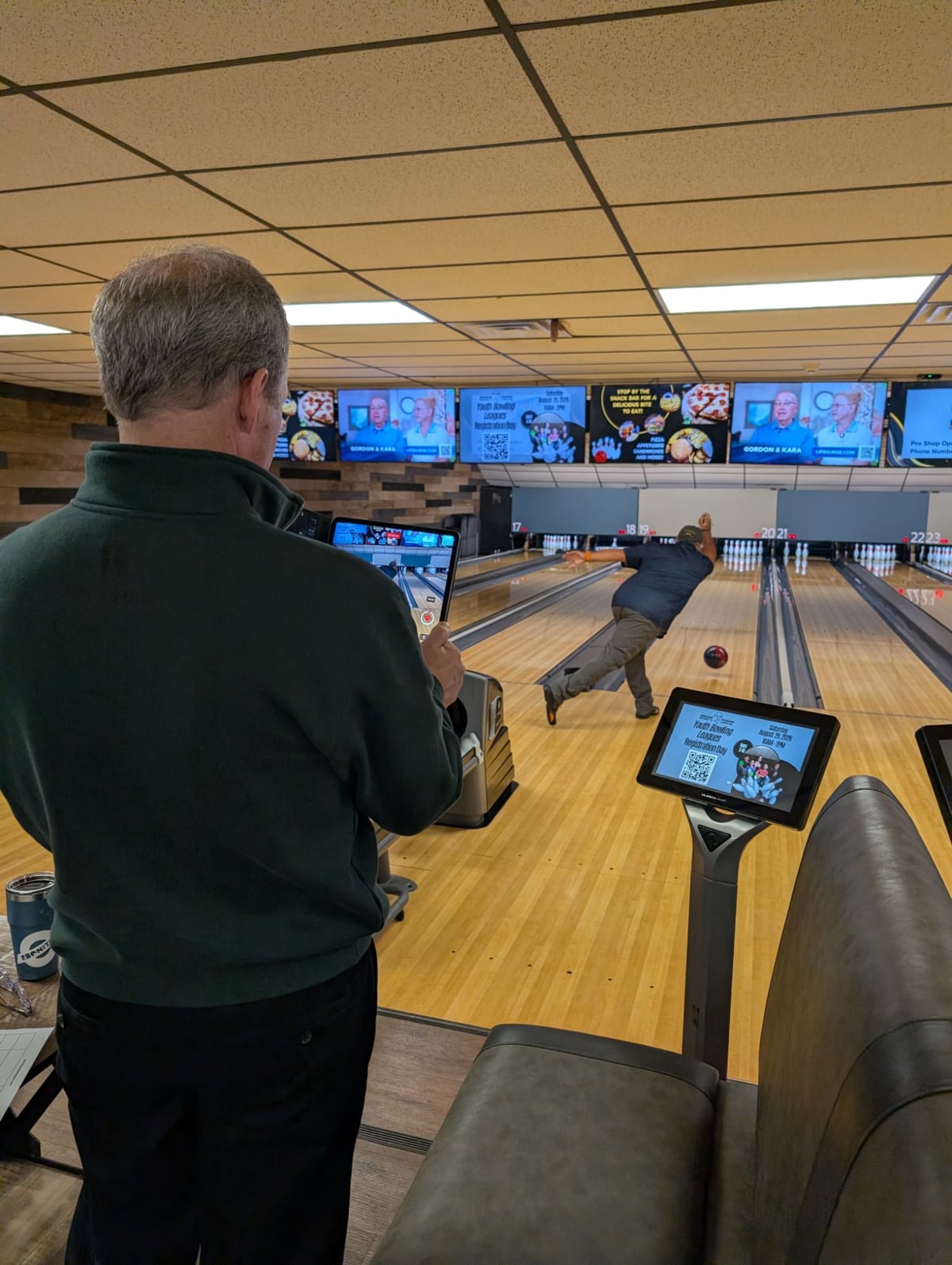 Mike Shady filming a bowler's release on a tablet