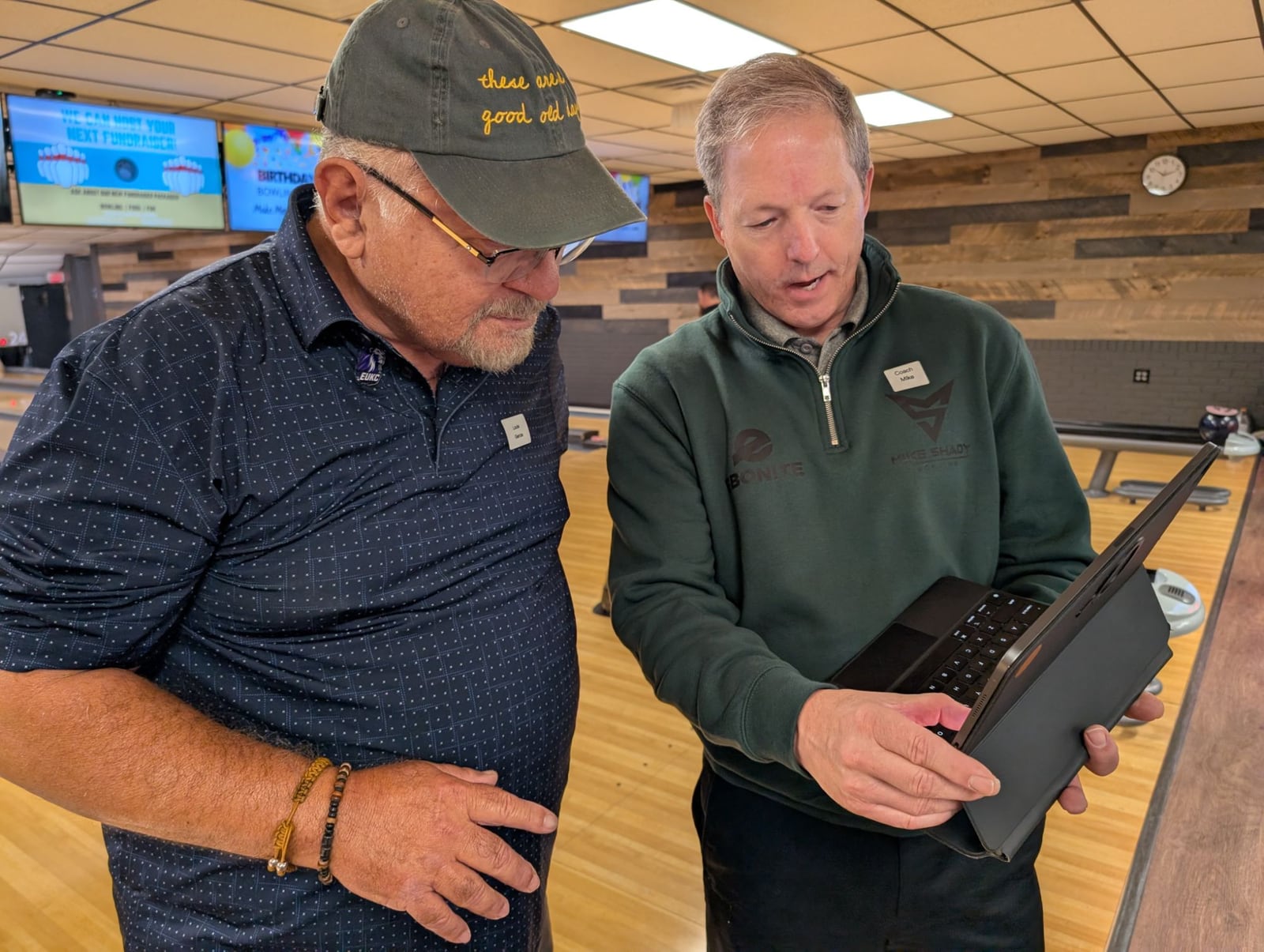 Mike Shady reviewing video on a tablet with a student at the lanes